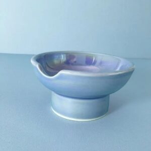 Our unique ashtray, with iridescent blue glaze and a footed design, elevates any decor