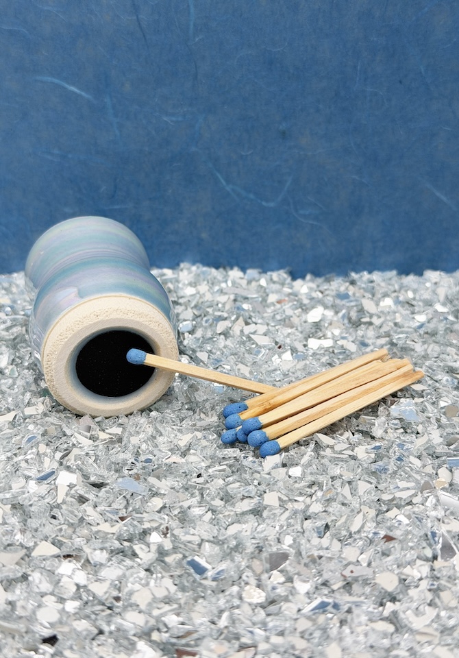 Strike the included color-coordinated safety matches on the hidden striking plate for a clean, modern light