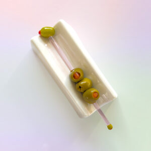 Add olives to our olive-themed glass stirrer for the ultimate martini